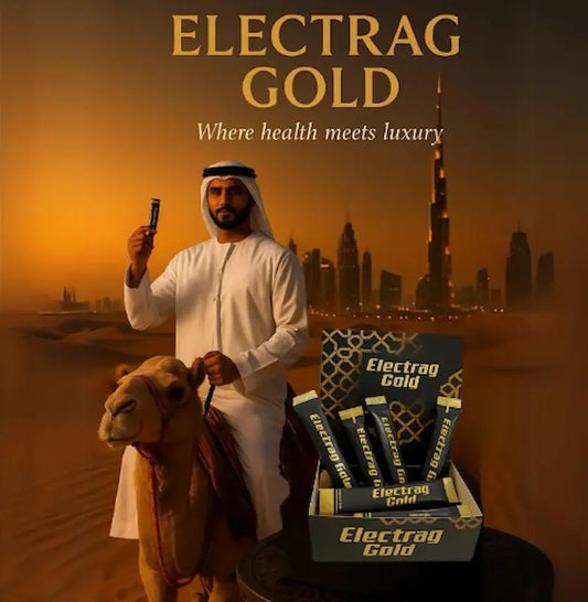 Emirati man sitting on a camel holding Electrag Gold sachet with a desert table setup, showcasing premium electrolyte drink in the UAE desert