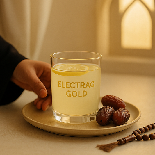Glass of Electrag Gold electrolyte drink served with dates and prayer beads for hydration during Ramadan in the UAE without breaking the fast