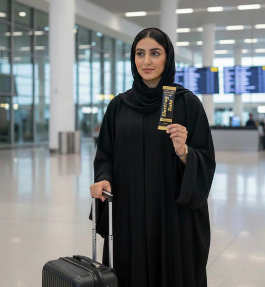 Traveler at Dubai International Airport holding an Electrag Gold sugar-free electrolyte sachet during a hydration-focused travel routine